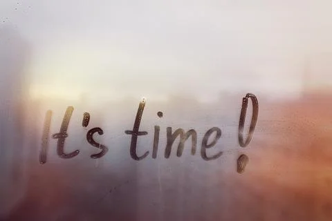 Hand drawn message Its time on foggy glass on city sunset window Stock Photos