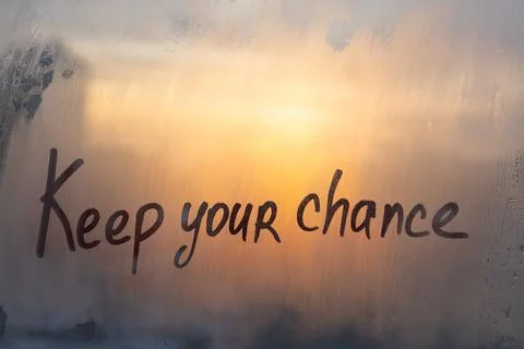 Hand drawn message Keep your chance on foggy glass of suset window Stock Photos