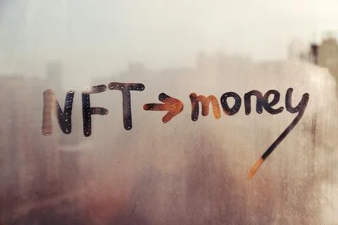 Hand drawn message NFT and arrow pointing towards money on foggy glass on suset Stock Photos