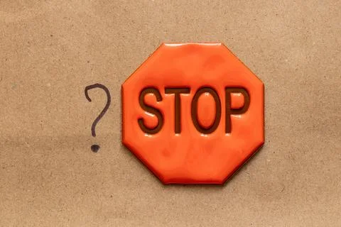 Hand drawn question mark and reflexive sign with stop text on brown paper Stock Photos