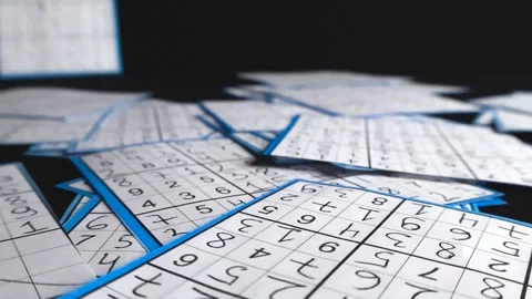 Hand drawn sudoku puzzles scattered on black background Stock Footage 340142468