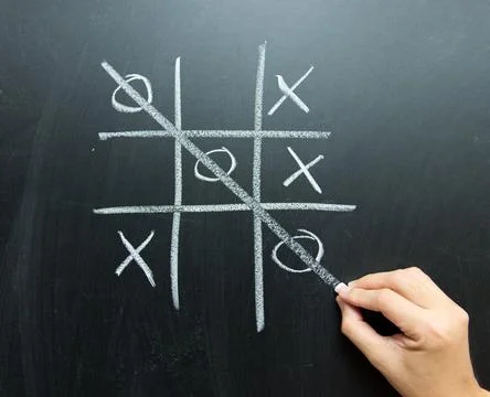 Hand drawn tic tac toe game on blackboard Stock Photos