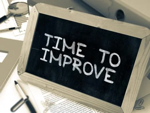 Hand Drawn Time to Improve Concept on Small Chalkboard Stock Illustration