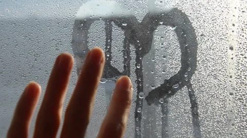 A hand draws a heart on a fogged window. Love, Valentine's Day, February 14th. Stock Footage 260402370