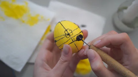 Hand draws a pattern on a chicken egg Stock Footage 310801178