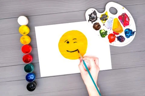 Hand draws smile on sheet Stock Photos