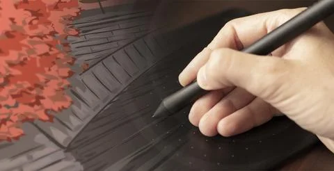A hand draws with a stylus on a graphics tablet Stock Photos