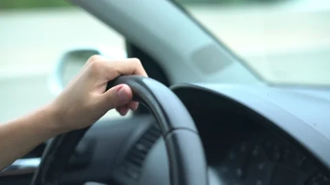 Hand of the driver on the car steering wheel while driving on the highway Video stock 113763655