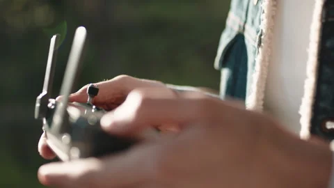 Hand of a Drone Operator man while pilot a quadcopter remote controller. Stock Footage 180555687