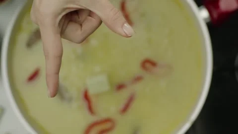 Hand Dropping Bouillon Cube into Simmering Soup Pot Top View 4K Vídeos de archivo 347364250
