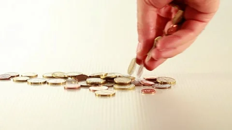Hand dropping coins Stock Footage 8659277