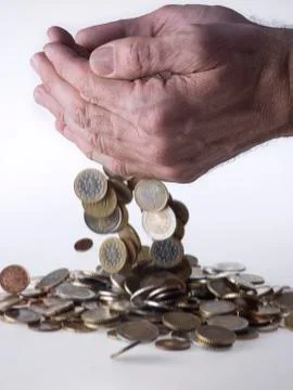 Hand dropping coins Stock Photos