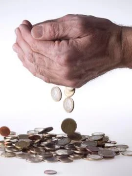 Hand dropping coins Stock Photos