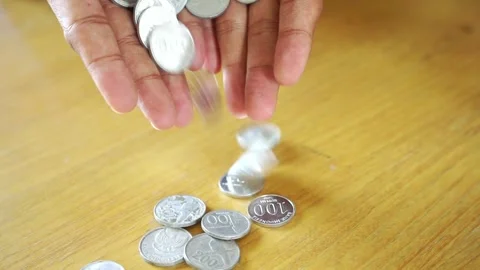 Hand dropping coins wealth and financial success amidst business recession. Stock Footage 322144507