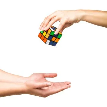 Hand dropping color cube Stock Photos