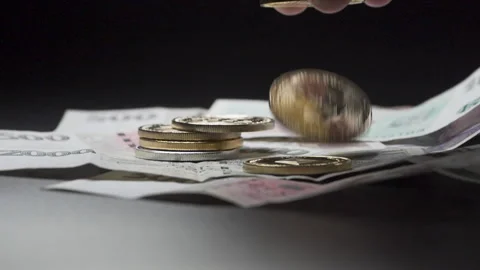 Hand dropping cryptocurrency coins on Czech money banknotes, close up. Stock Footage