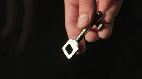 A hand dropping a key in an aquarium Stock Footage 24896459