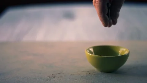 Hand dropping money into a tip jar bowl Stock Footage 326357741