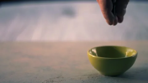 Hand dropping money into a tip jar bowl Stock-Footage 327221080