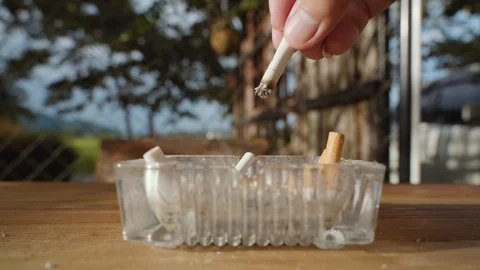 Hand dropping smoking cigarette Stock Footage 97255408