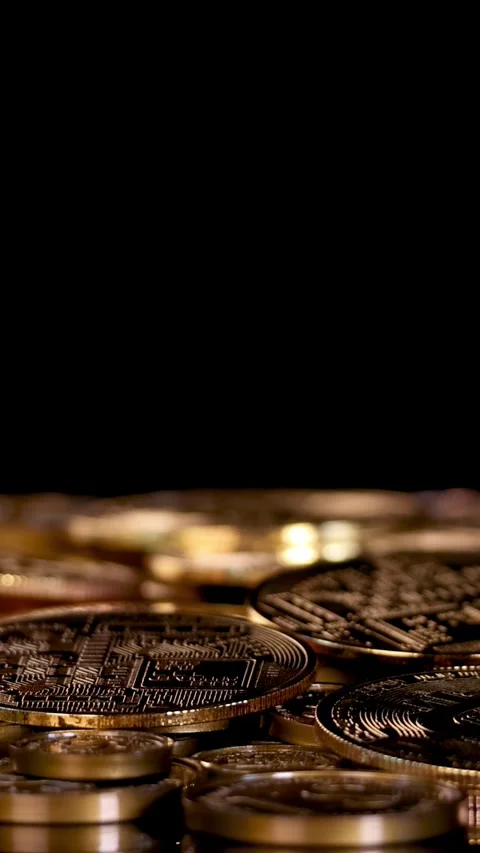 Hand Drops Bitcoin Token Onto Stack of Golden Coins Stock Footage 316734534