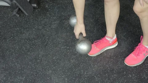 Hand drops dumbbell weight slow motion Stock Footage 249290335