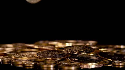 Hand Drops Gold Cryptocurrency Coin Onto Stack of Tokens Stock Footage 316016229