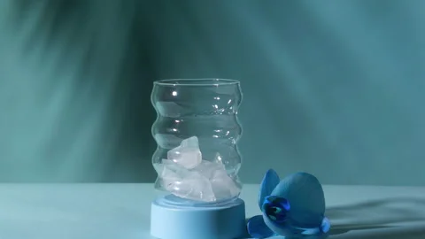 Hand Drops Ice Cubes into Bubble Glass with Dynamic Zoom In Shot and Orchid Stock Footage 334264542