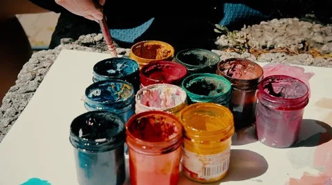 Hand dunks brush in a jar with gouache Stock Footage 55806190