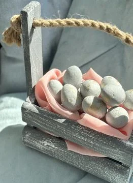 Hand-Dyed Easter Eggs in Rustic Basket Stock Photos