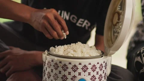 Hand Eating Rice Directly from a Rice Cooker, Greedy Concept Stock Footage 344235801