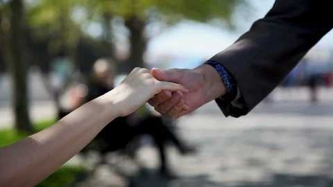 Hand of an Elderly man holding the hand of a young woman, close- up Video stock 114263864