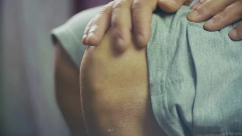 The hand of an elderly man stroking a sore knee Stock Footage 337695622