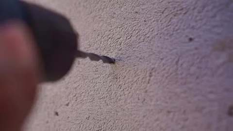 Hand electric drill boring into concrete wall, home renovation construction Stockbeeldmateriaal 345293539
