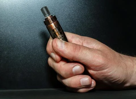 Hand with electronic cigarette Stock Photos