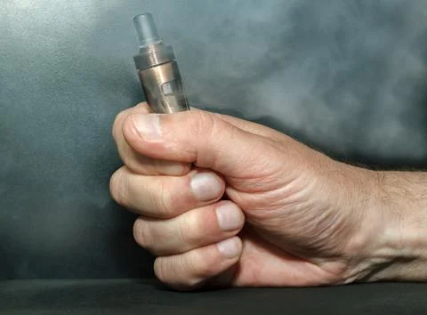 Hand with electronic cigarette Stock Photos