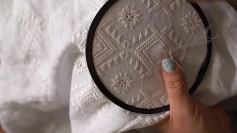 Hand embroidery techniques shown on white fabric with detailed stitching Stock Footage 327282964
