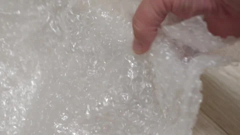 Hand Engages with Bubble Wrap, Evoking Nostalgia and Anticipation. Stock Footage 318787362