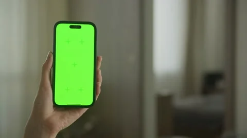 Hand enter frame from left holding phone... | Stock Video | Pond5