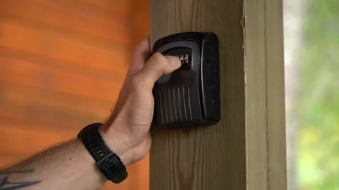 Hand entering code and opening lockbox to take out key from the inside - 스톡 동영상 209262155