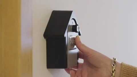 Hand entering code and opening lockbox to take out key from the inside 스톡 동영상 276189672