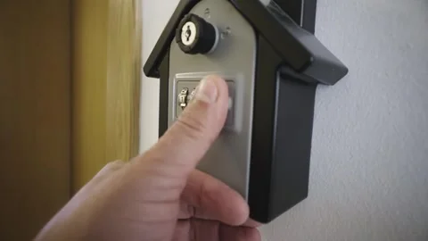 Hand entering code and opening lockbox to take out key from the inside 스톡 동영상 308657730