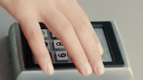 Hand entering code on electronic combination lock to access door. Vertical video Stock Footage 297552771