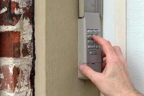 Hand entering code on keypad - garage door opener - home security 스톡 사진
