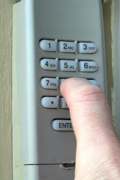 Hand entering code on keypad - garage door opener - home security Stock Photos