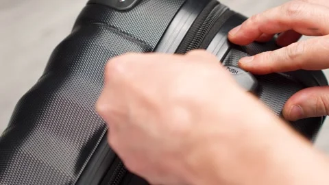 Hand entering code for open black suitcase. Close up hand close suitcase wi.. Stock Footage 275592878