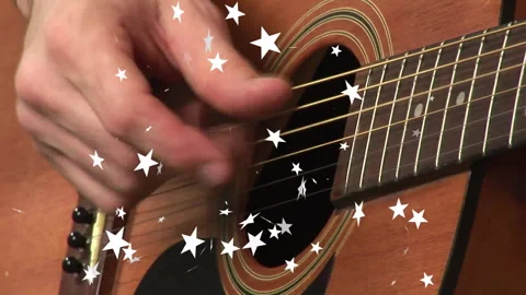 Hand entering frame causing strum, strumming along strings for rhythmic beat Stock Footage 313329240