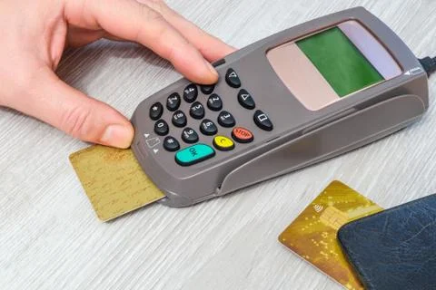 Hand entering pin code to money terminal before payment Stock Photos