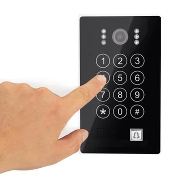A hand is entering a security code on a black access control keypad with camera Stock Photos