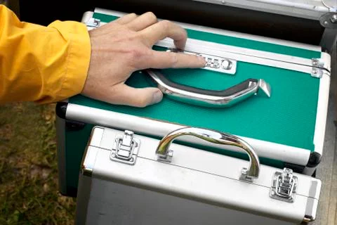 Hand entering security code on briefcase Stock Photos